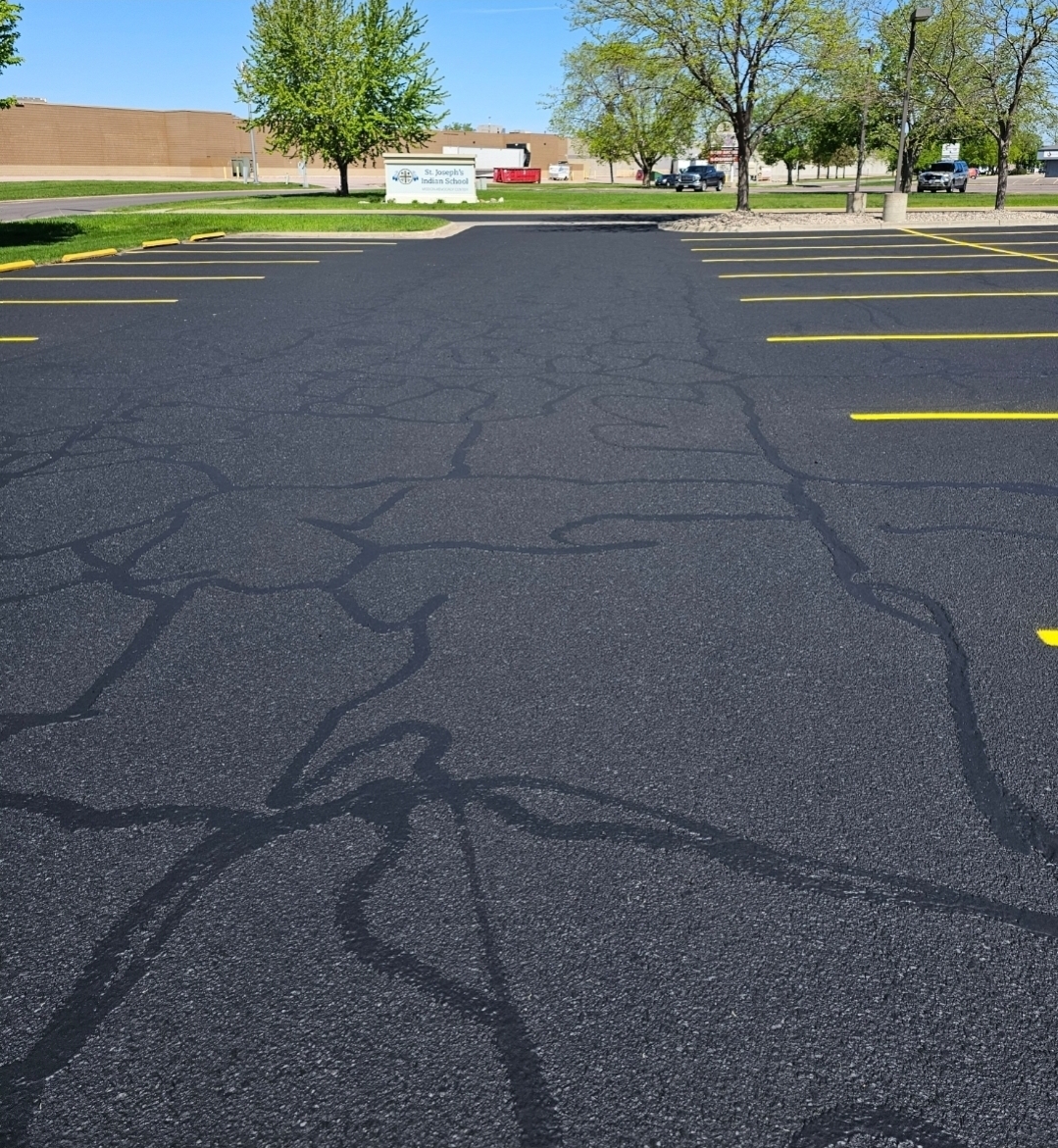Hot rubberized crack filler being applied